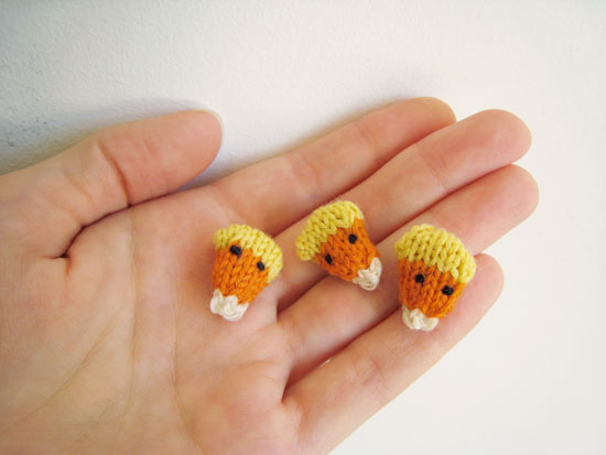 Tiny knitted candy corn decorations in Cascade Heritage sock yarn.